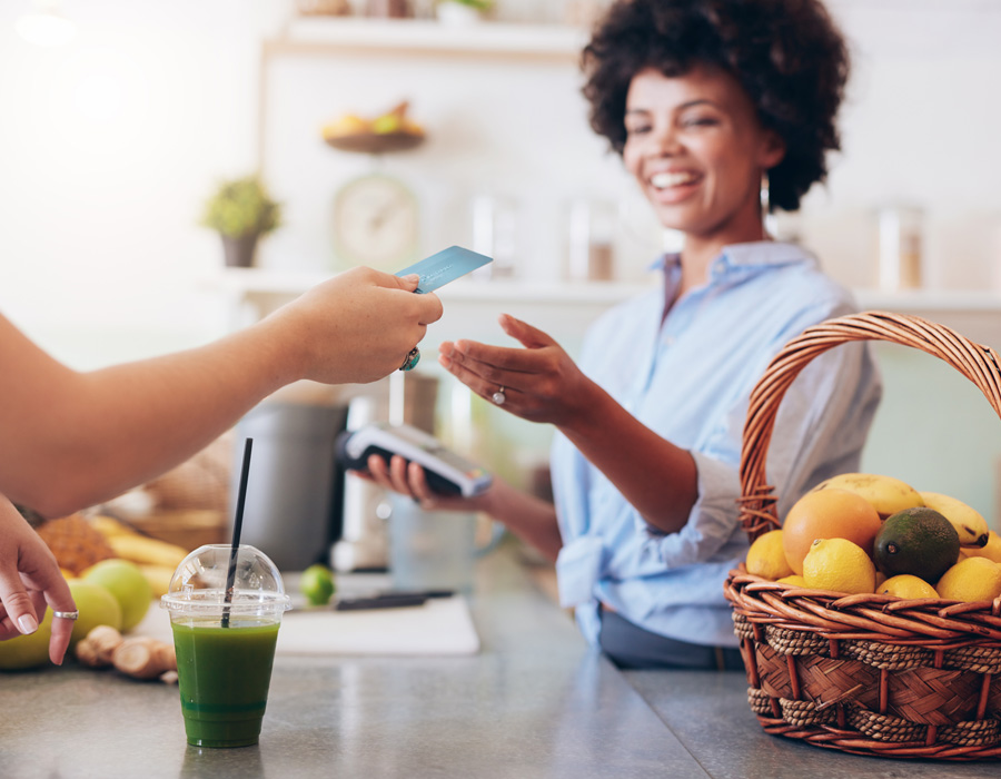 Woman using credit card for a juice.